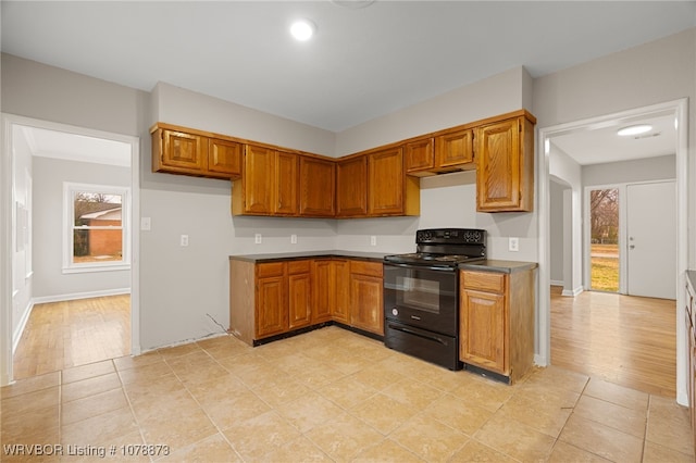 kitchen with light tile patterned floors and electric range