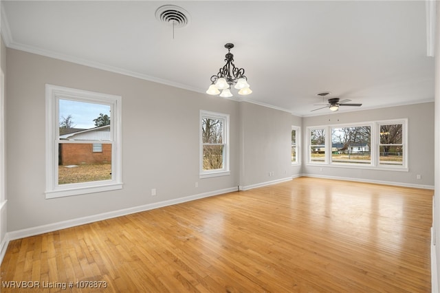 empty room with ceiling fan with notable chandelier, ornamental molding, and light hardwood / wood-style floors