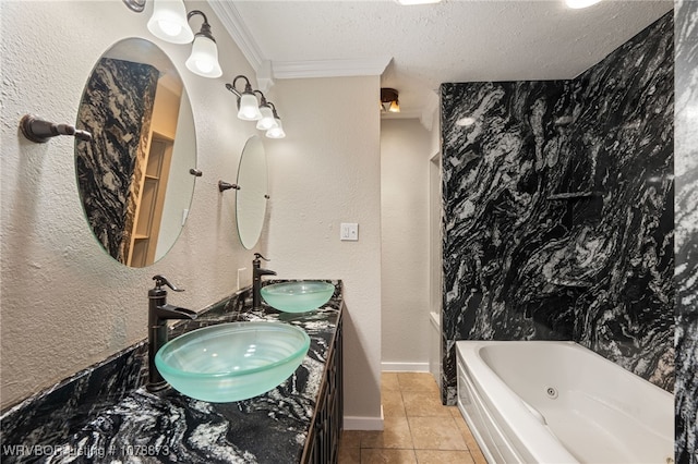 bathroom featuring tile patterned floors, crown molding, a textured ceiling, vanity, and a washtub