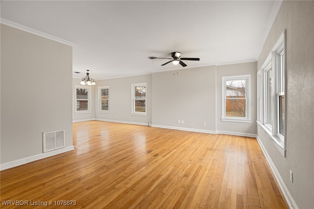 unfurnished living room featuring crown molding, ceiling fan with notable chandelier, and light wood-type flooring