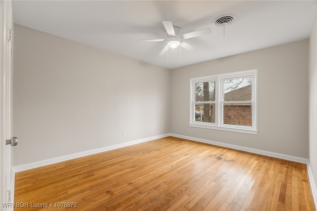 empty room with hardwood / wood-style floors and ceiling fan