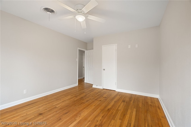 unfurnished room with ceiling fan and wood-type flooring