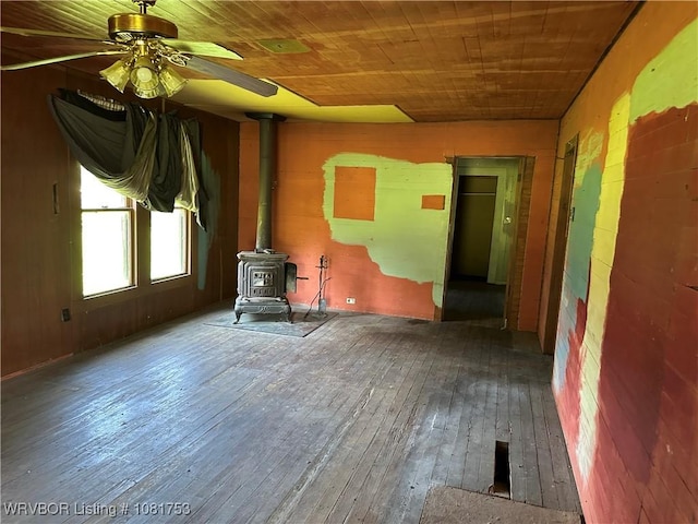3329 Furry Way, Van Buren, AR 72956 - unfurnished living room with a wood stove, hardwood / wood-style floors, ceiling fan, wood ceiling, and wood walls