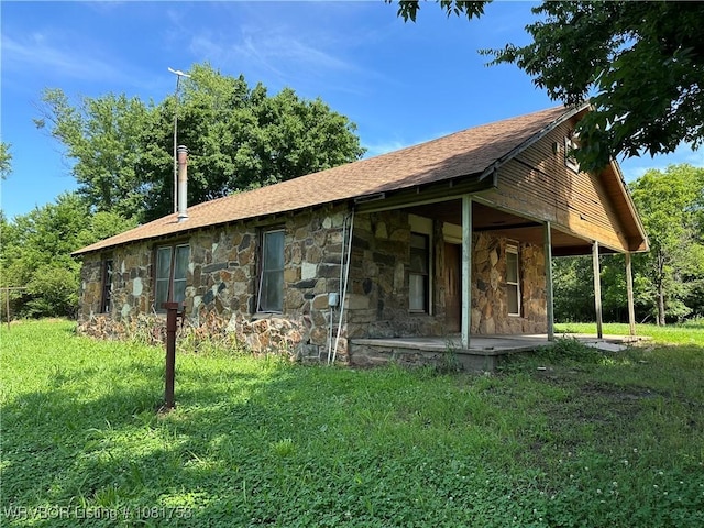 3329 Furry Way, Van Buren, AR 72956 - rear view of property featuring stone siding, a shingled roof, and a lawn