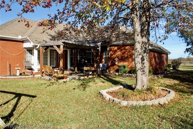 rear view of house with a patio area and a lawn