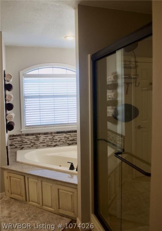 bathroom with tile patterned floors and separate shower and tub