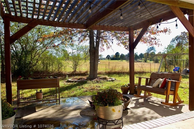 view of patio with a rural view and a pergola