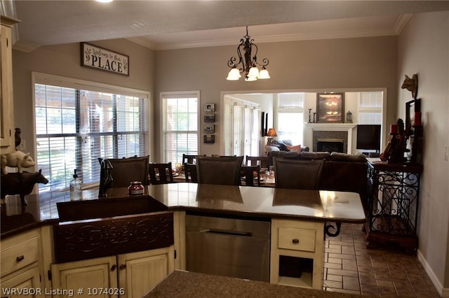 kitchen featuring cream cabinets, dishwasher, plenty of natural light, and a notable chandelier