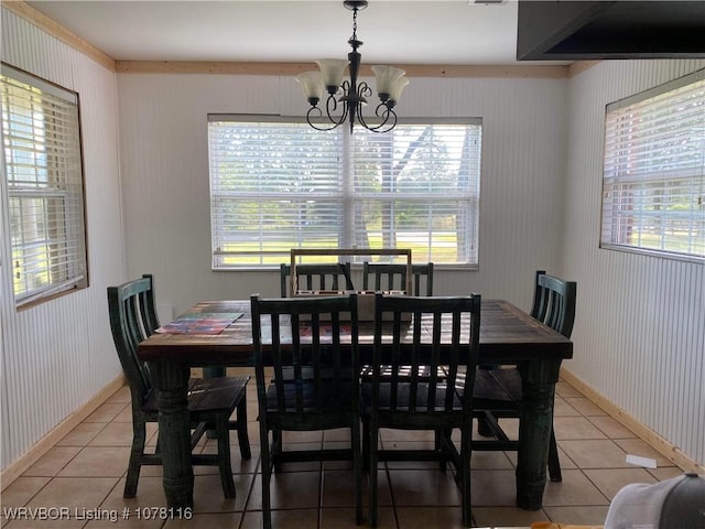 dining room with tile patterned floors and a chandelier