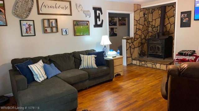 living room with hardwood / wood-style flooring and a wood stove