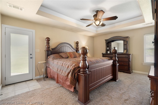 bedroom with a tray ceiling, ceiling fan, crown molding, and light tile patterned flooring