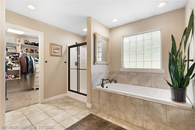 bathroom featuring plus walk in shower and tile patterned flooring