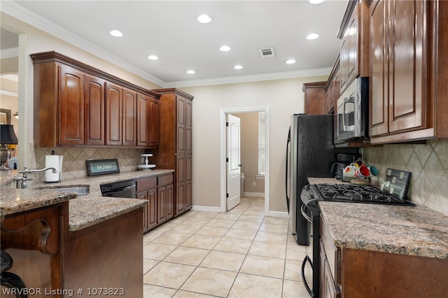 kitchen featuring sink, light stone counters, crown molding, light tile patterned floors, and appliances with stainless steel finishes