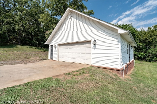 view of side of property with an outbuilding, a yard, and a garage