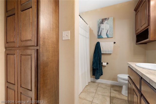 bathroom with tile patterned floors, vanity, and toilet