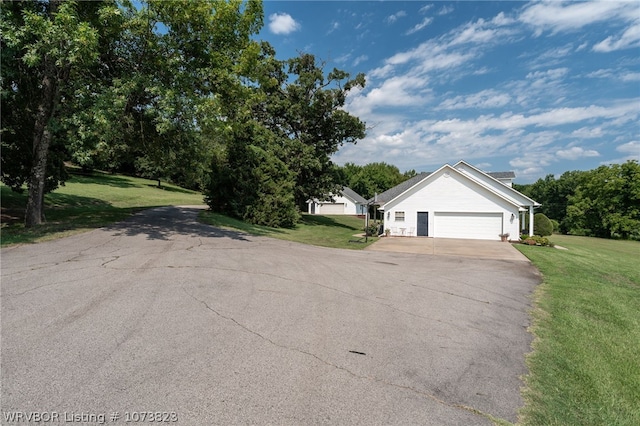 exterior space featuring a front lawn and a garage