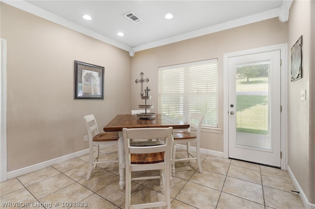 dining room featuring ornamental molding and light tile patterned flooring