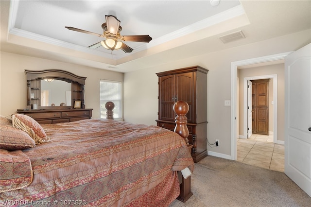 bedroom with a raised ceiling, ceiling fan, crown molding, and light carpet