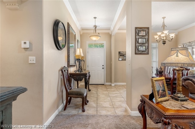 tiled entryway featuring crown molding and a notable chandelier