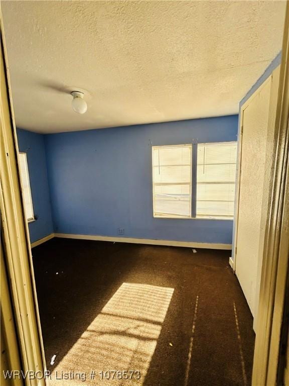 unfurnished bedroom with a textured ceiling