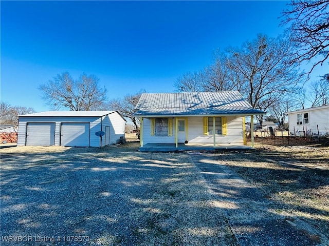 view of front of property with an outbuilding, a garage, and a porch