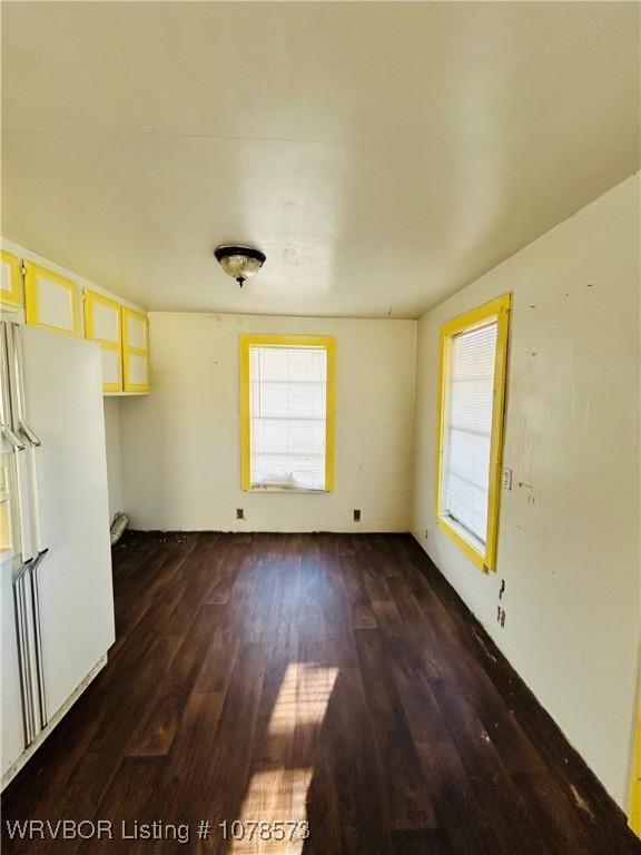 unfurnished living room with dark wood-type flooring