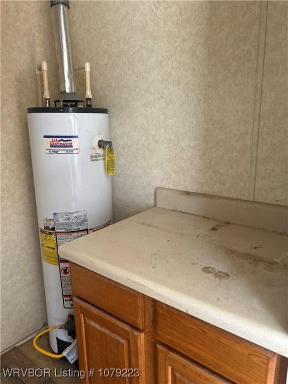 utility room featuring water heater