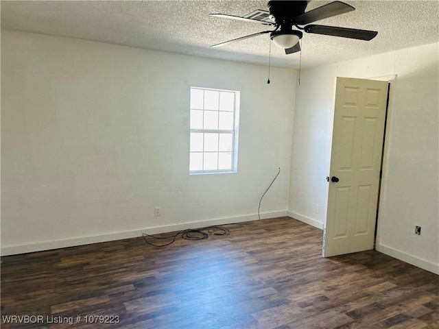 unfurnished room featuring a textured ceiling, ceiling fan, dark wood finished floors, and baseboards