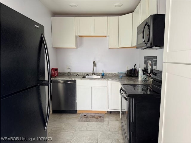 kitchen with white cabinetry, black appliances, and a sink