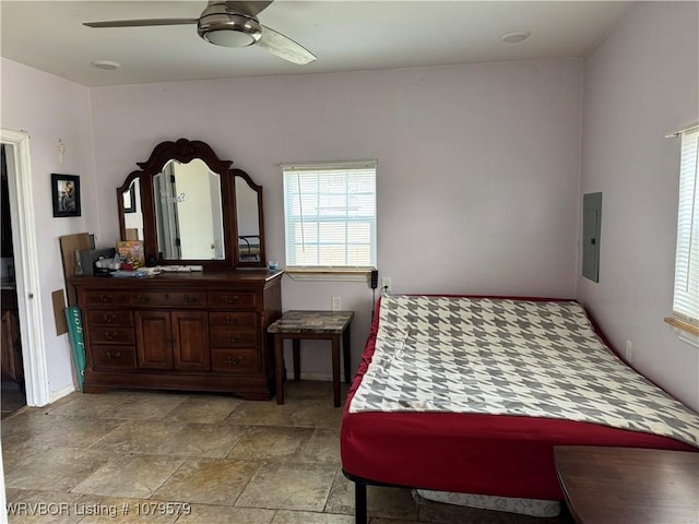 bedroom featuring electric panel and a ceiling fan