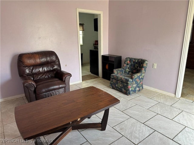 sitting room featuring light tile patterned floors and baseboards