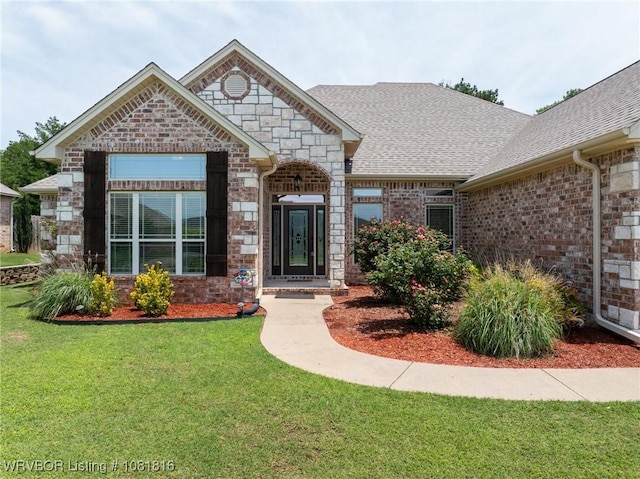 12905 Limestone Dr, Fort Smith, AR 72916 - french provincial home with a front yard, roof with shingles, brick siding, and stone siding