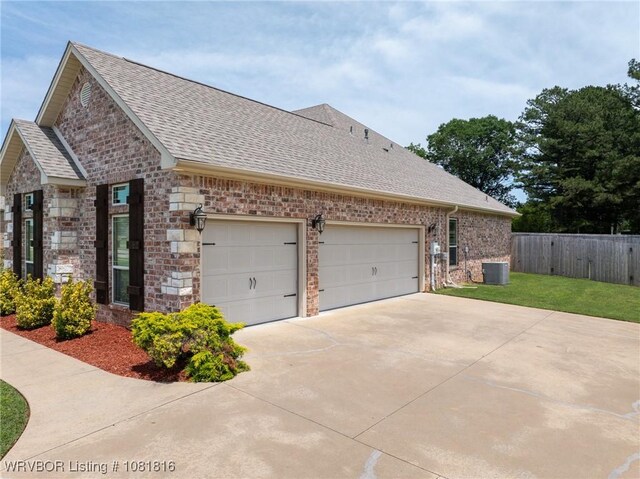 12905 Limestone Dr, Fort Smith, AR 72916 - view of home's exterior featuring roof with shingles, driveway, a garage, brick siding, and stone siding