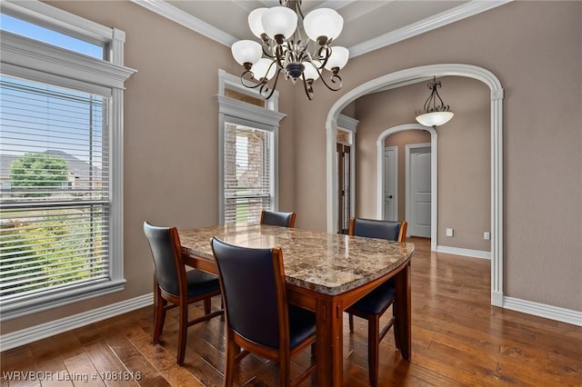 12905 Limestone Dr, Fort Smith, AR 72916 - dining space featuring a chandelier, arched walkways, dark wood-style floors, and crown molding