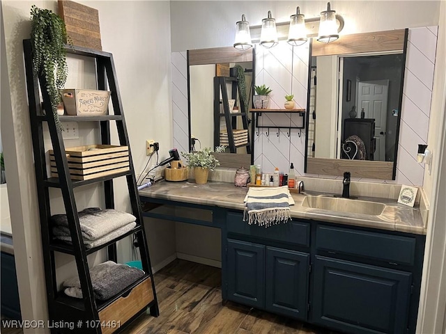 bathroom featuring hardwood / wood-style flooring, decorative backsplash, and vanity