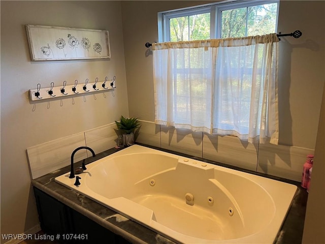 bathroom featuring tiled tub