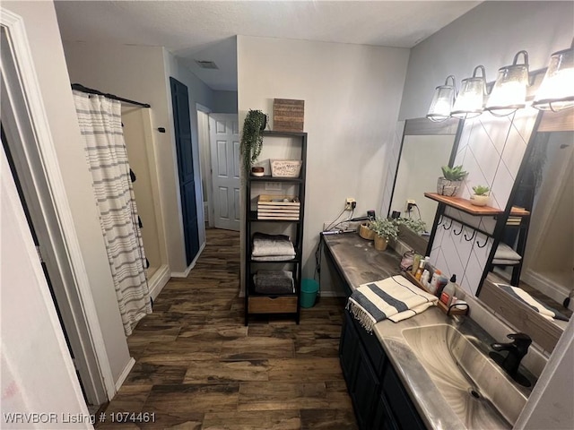 interior space featuring vanity, a shower with shower curtain, and hardwood / wood-style flooring