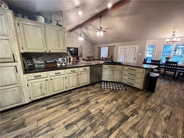 kitchen featuring tasteful backsplash, vaulted ceiling with beams, stainless steel dishwasher, kitchen peninsula, and cream cabinetry