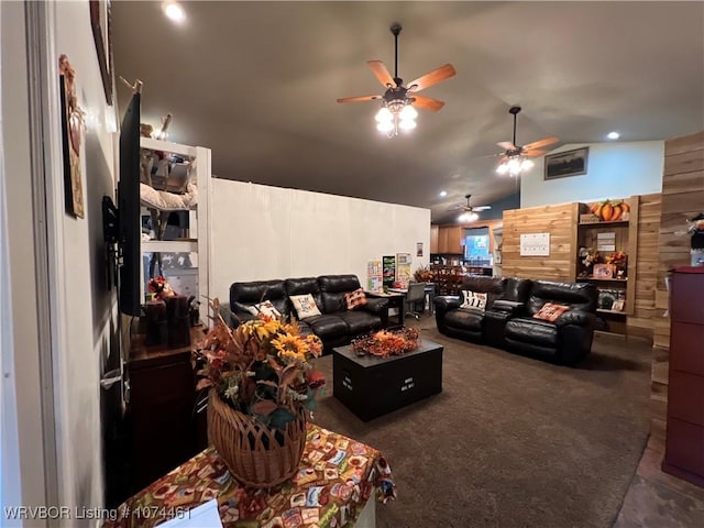 living room featuring ceiling fan, dark carpet, and vaulted ceiling