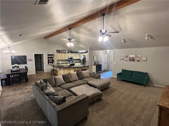 living room featuring ceiling fan with notable chandelier, lofted ceiling with beams, a textured ceiling, and dark colored carpet