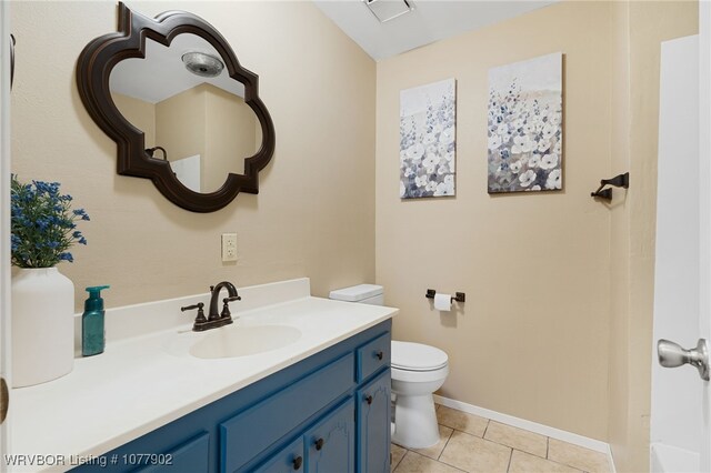 bathroom featuring tile patterned floors, vanity, and toilet