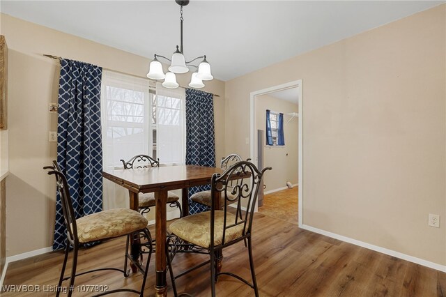 dining room featuring a chandelier and wood-type flooring