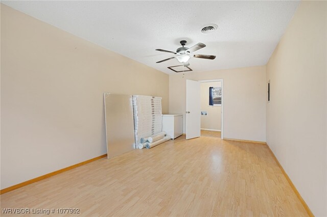 spare room featuring ceiling fan, a textured ceiling, and hardwood / wood-style flooring