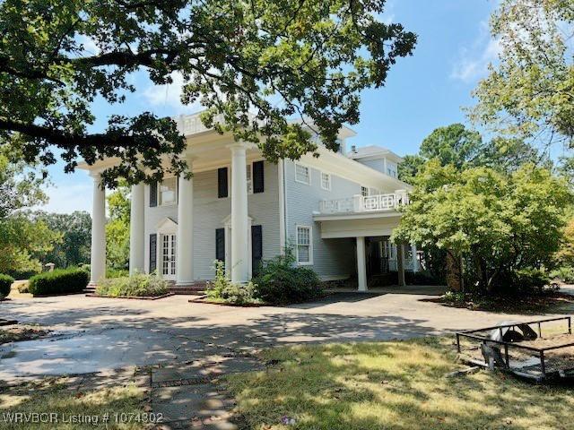 neoclassical / greek revival house featuring a balcony