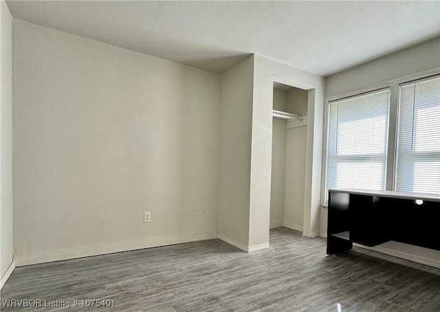 bedroom featuring hardwood / wood-style floors and a closet