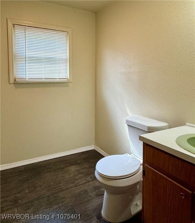 bathroom featuring hardwood / wood-style floors, vanity, and toilet