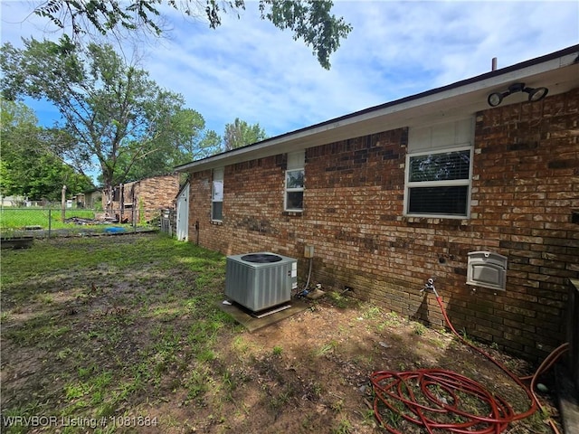 203 Ohio Ln, Lavaca, AR 72941 - view of home's exterior with a central air condition unit and brick siding