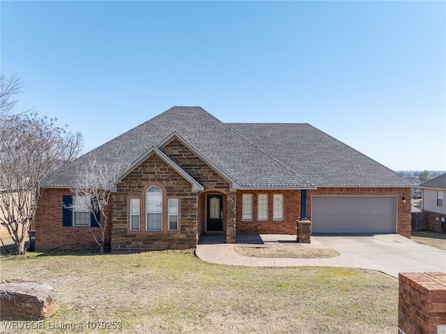 view of front of home featuring brick siding, a shingled roof, concrete driveway, a front yard, and a garage