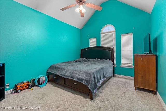 carpeted bedroom featuring baseboards, vaulted ceiling, and a ceiling fan