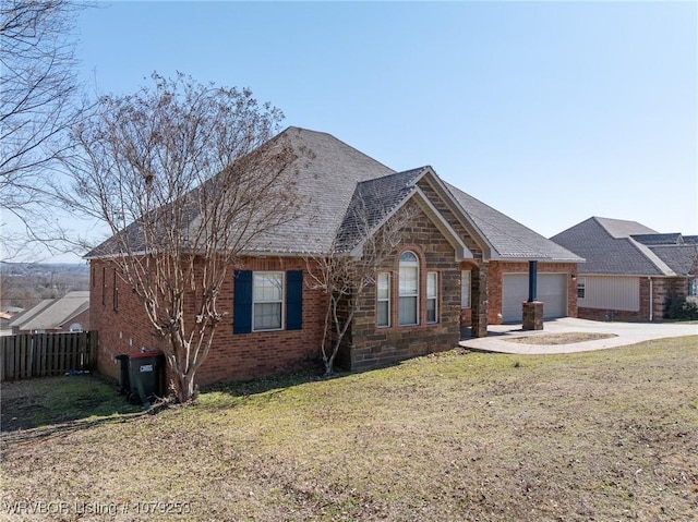 view of front of home with concrete driveway, a front lawn, and an attached garage